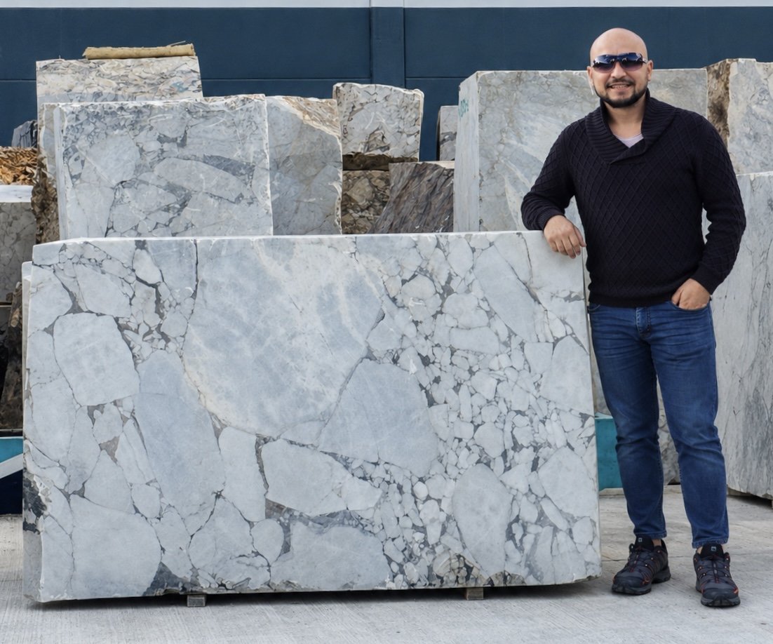 Anatolia Marble Project founder standing beside natural marble blocks in Türkiye