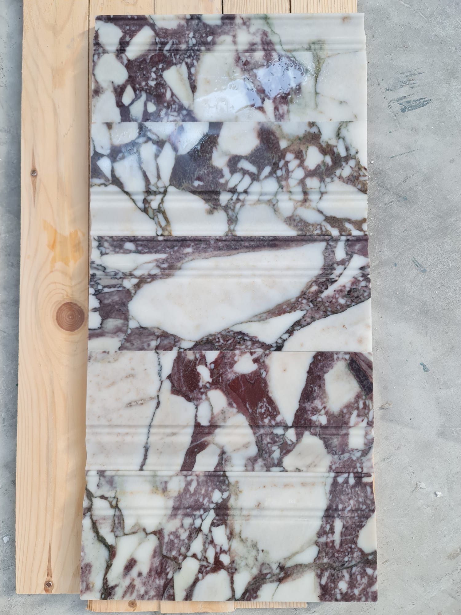 Mouldings · Calacatta Viola Extra Base · Honed natural stone moulding — surface and veining